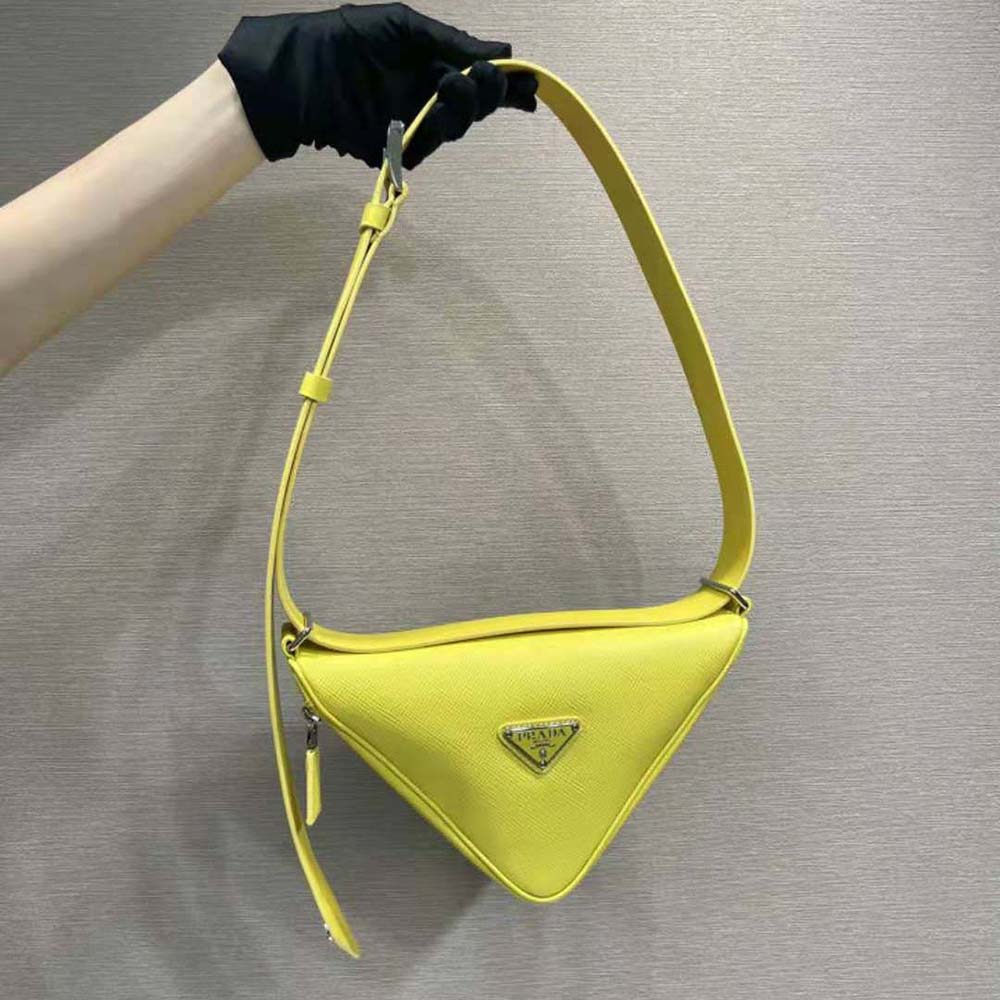 Close-up on yellow Saffiano leather texture and silver hardware detail