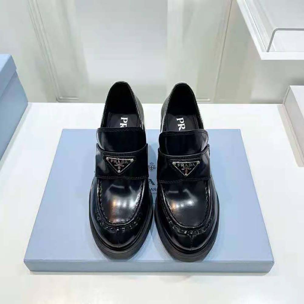Close-up on black brushed leather and Prada logo hardware detail