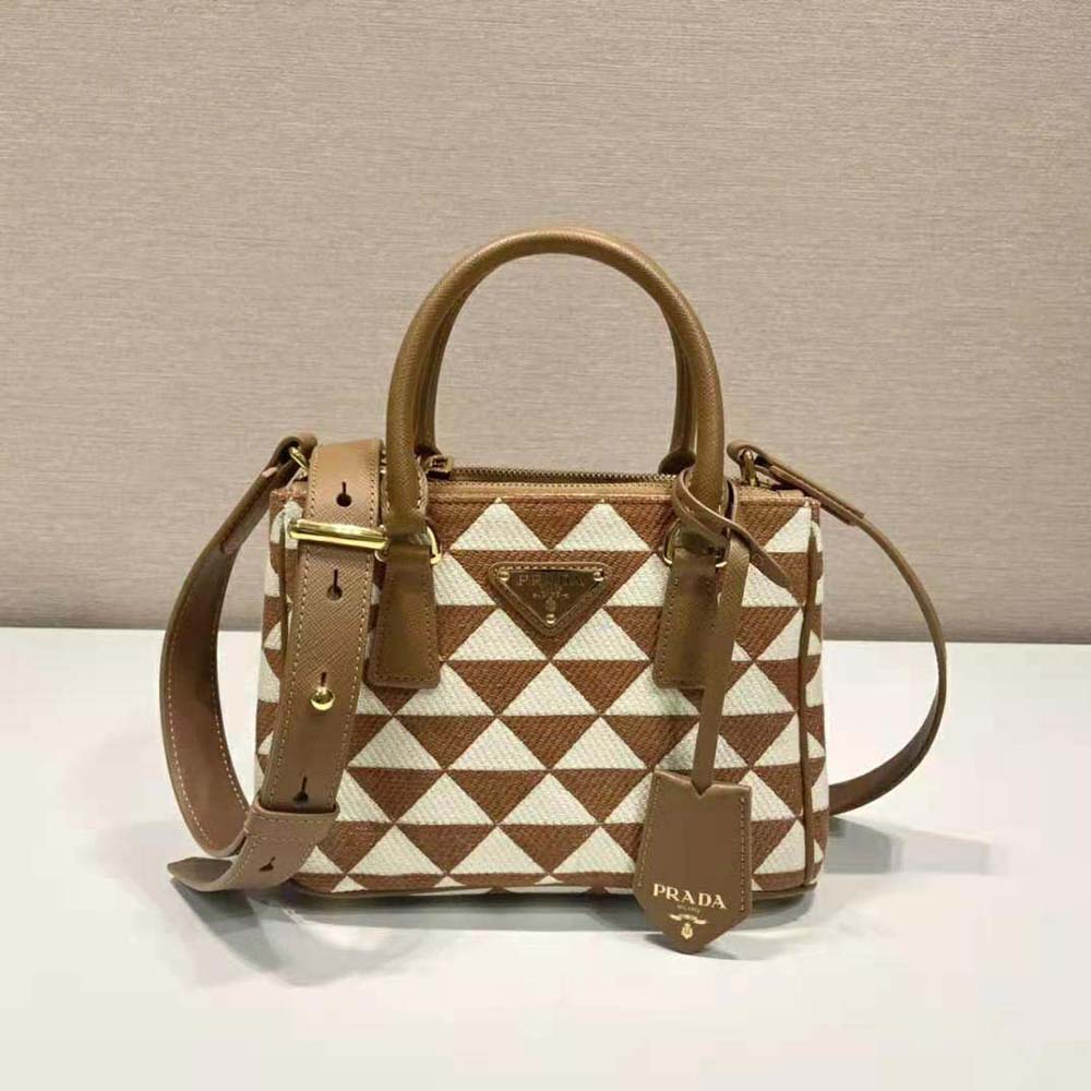 Close-up of embroidered jacquard fabric on Prada micro-bag in brown