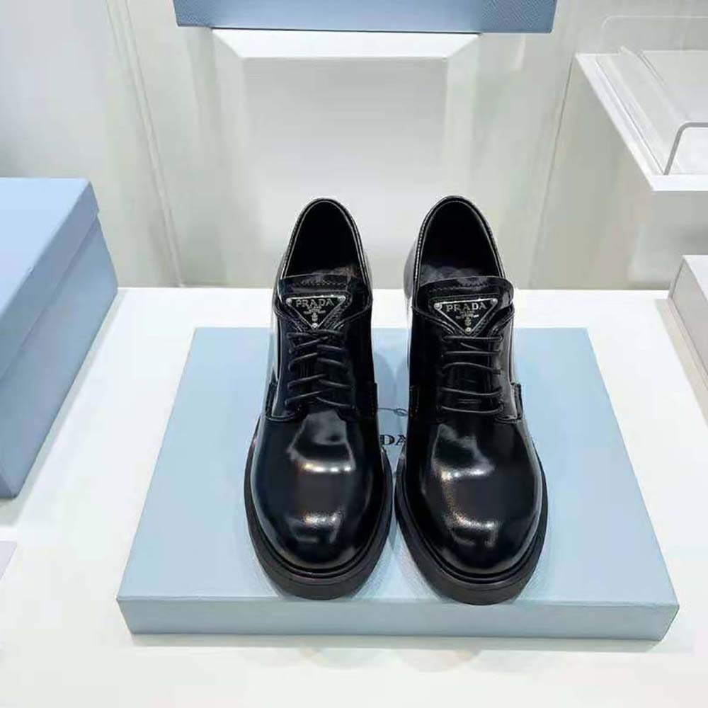 Close-up of lace detail and brushed leather texture on Prada Women Heeled Lace-Ups
