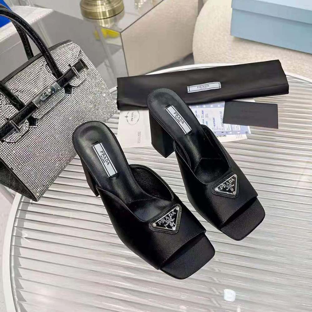 Close-up on Prada logo hardware of High-Heeled Satin Slides-Black