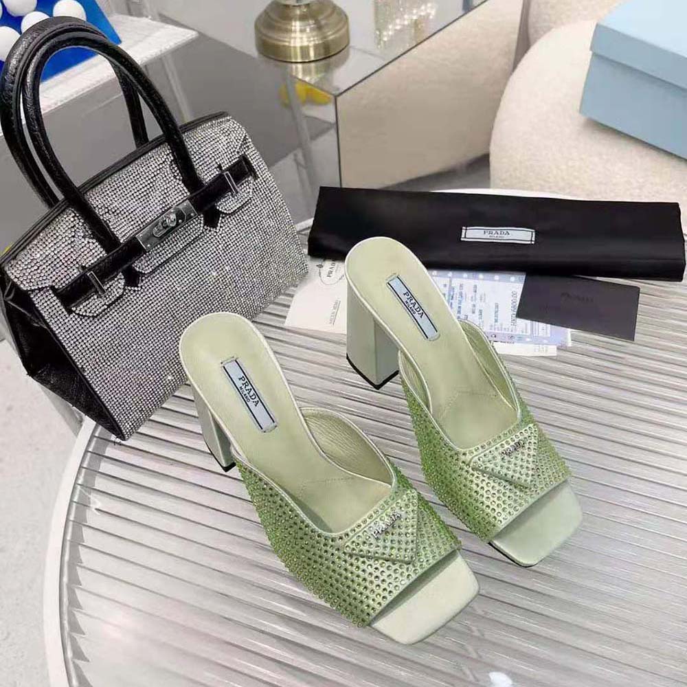 Close-up of crystal embellishments on Prada aqua satin slides