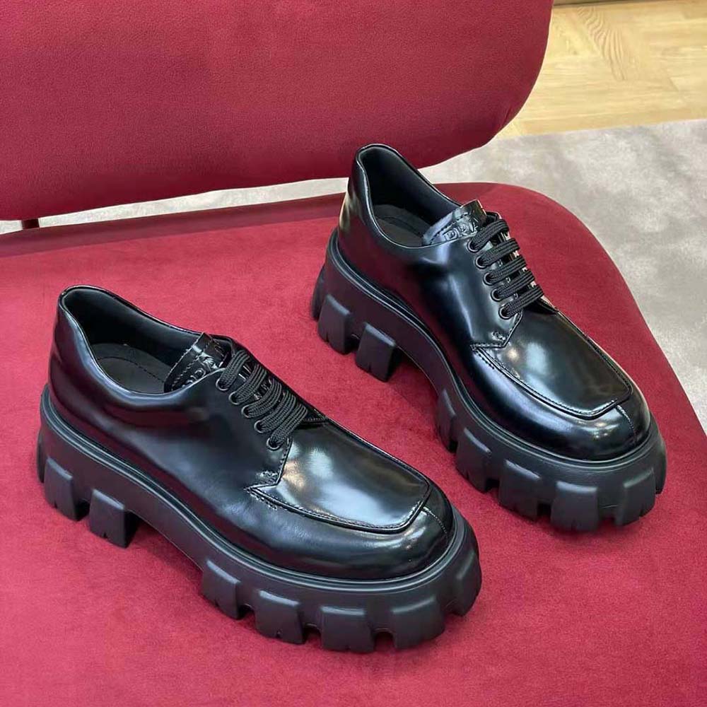 Close-up detail of brushed leather texture on Prada Monolith lace-up shoes