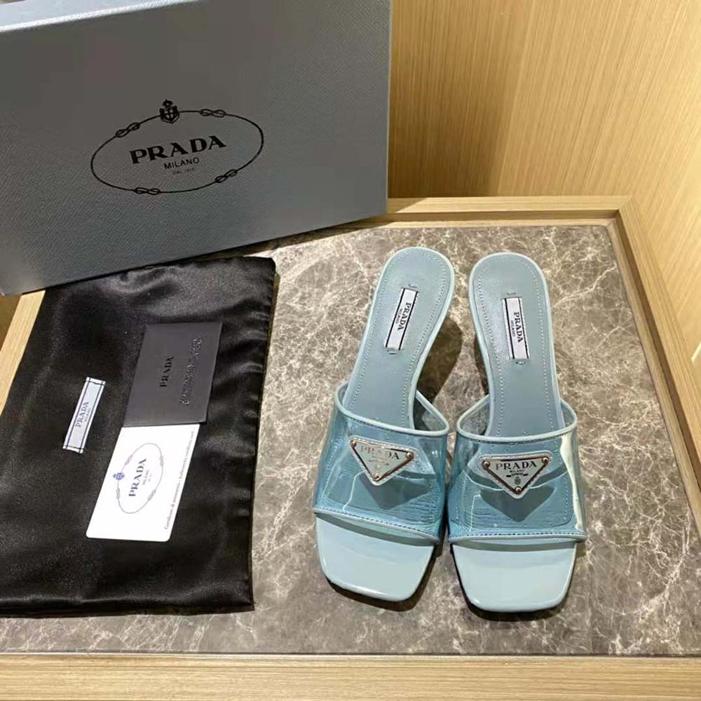 Close-up of blue patent leather and plexiglas strap on Prada sandals