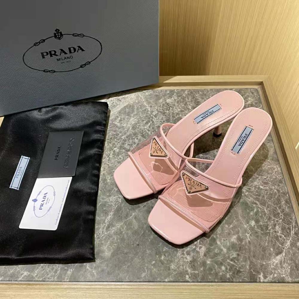 Side view showing plexiglas straps and Prada signature hardware on pink sandals