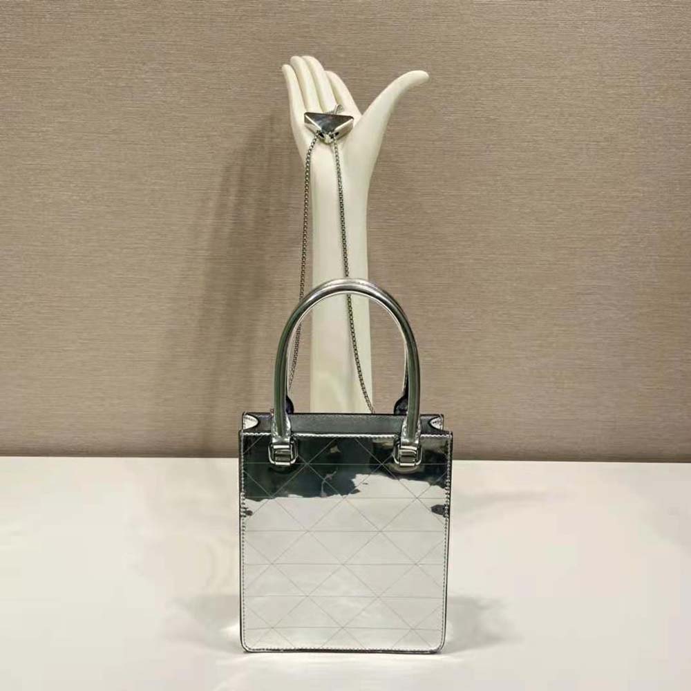 Side angle showing zip closure and shoulder strap on Prada metallic tote