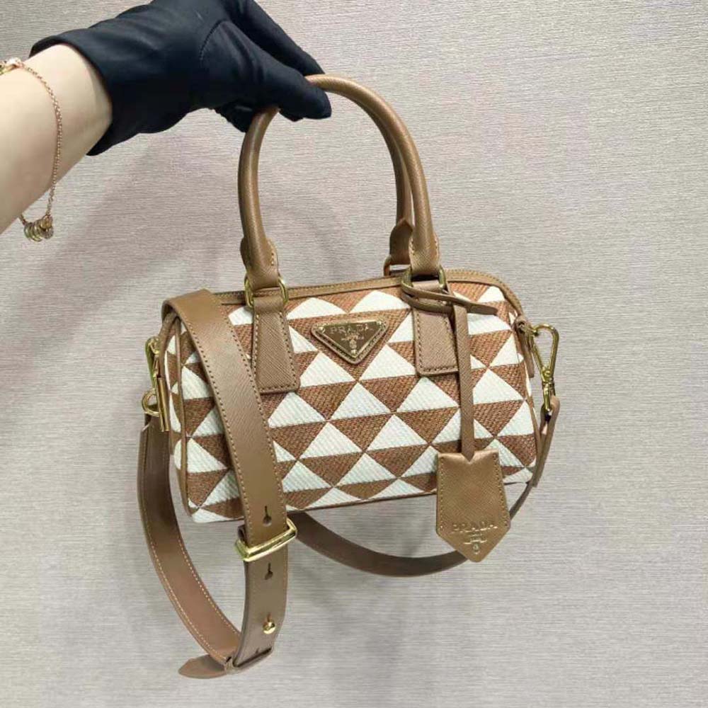 Close-up of embroidered jacquard fabric and gold-tone hardware on Prada bag