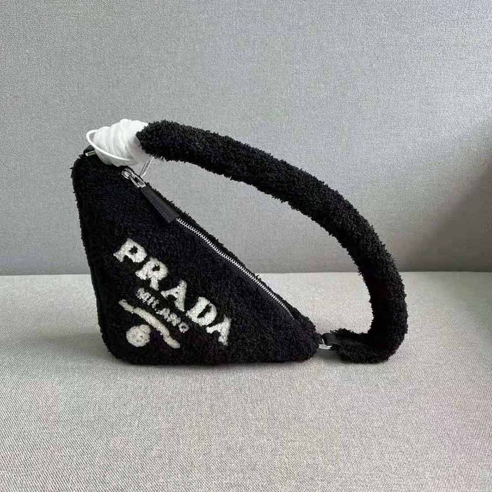 Close-up of black terrycloth texture and embroidered Prada logo on pouch