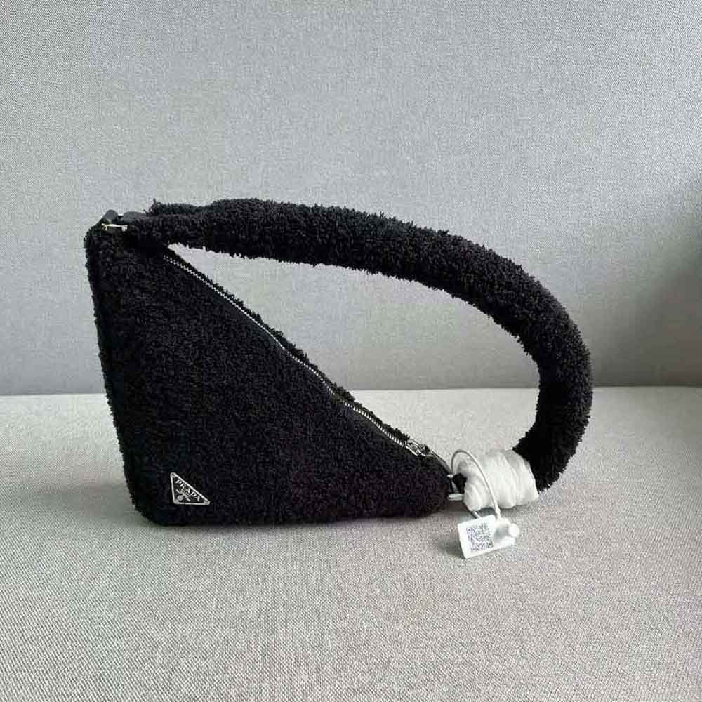 Side angle showing zip closure and silver-tone hardware details on pouch