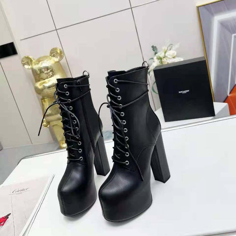 Close-up of silver YSL logo on Saint Laurent YSL Women Cherry Booties