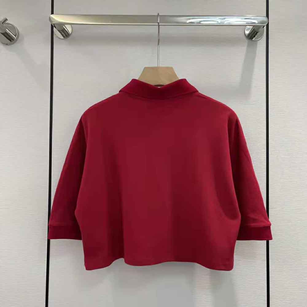 Side angle showing tailored cropped fit of Saint Laurent YSL polo shirt
