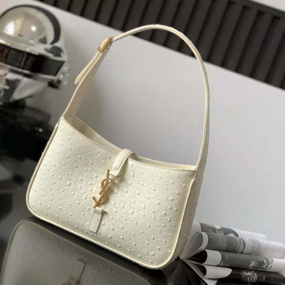 Close-up of polished silver YSL logo on Ostrich-White hobo bag