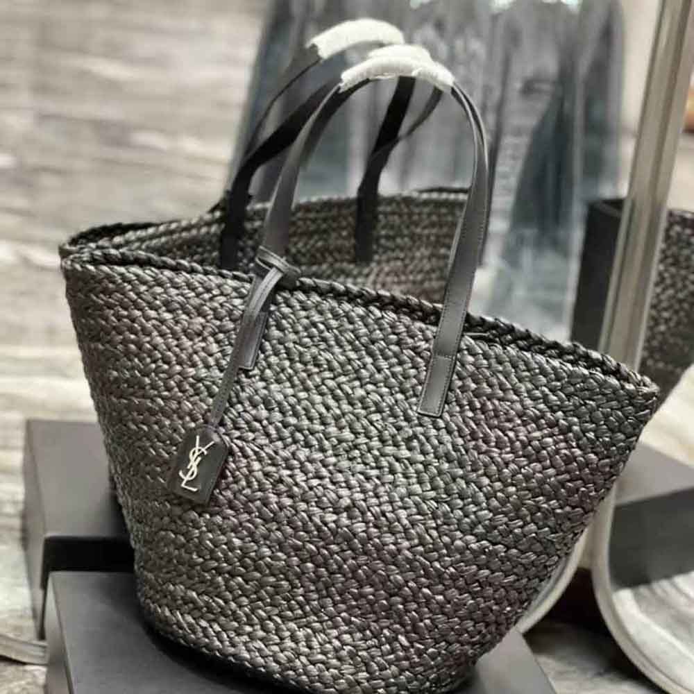 Side angle showing woven raffia texture and black leather trim on Saint Laurent bag