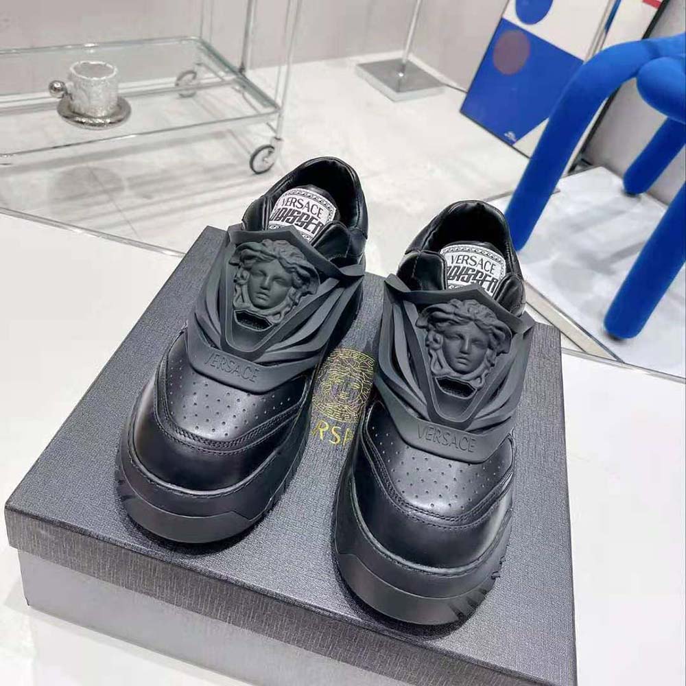 Top view of sleek black Versace Unisex Odissea Sneakers rubber soles