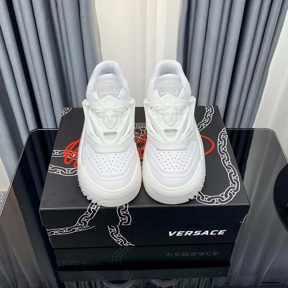 Close-up of signature Versace logo on white Odissea Sneakers rubber sole