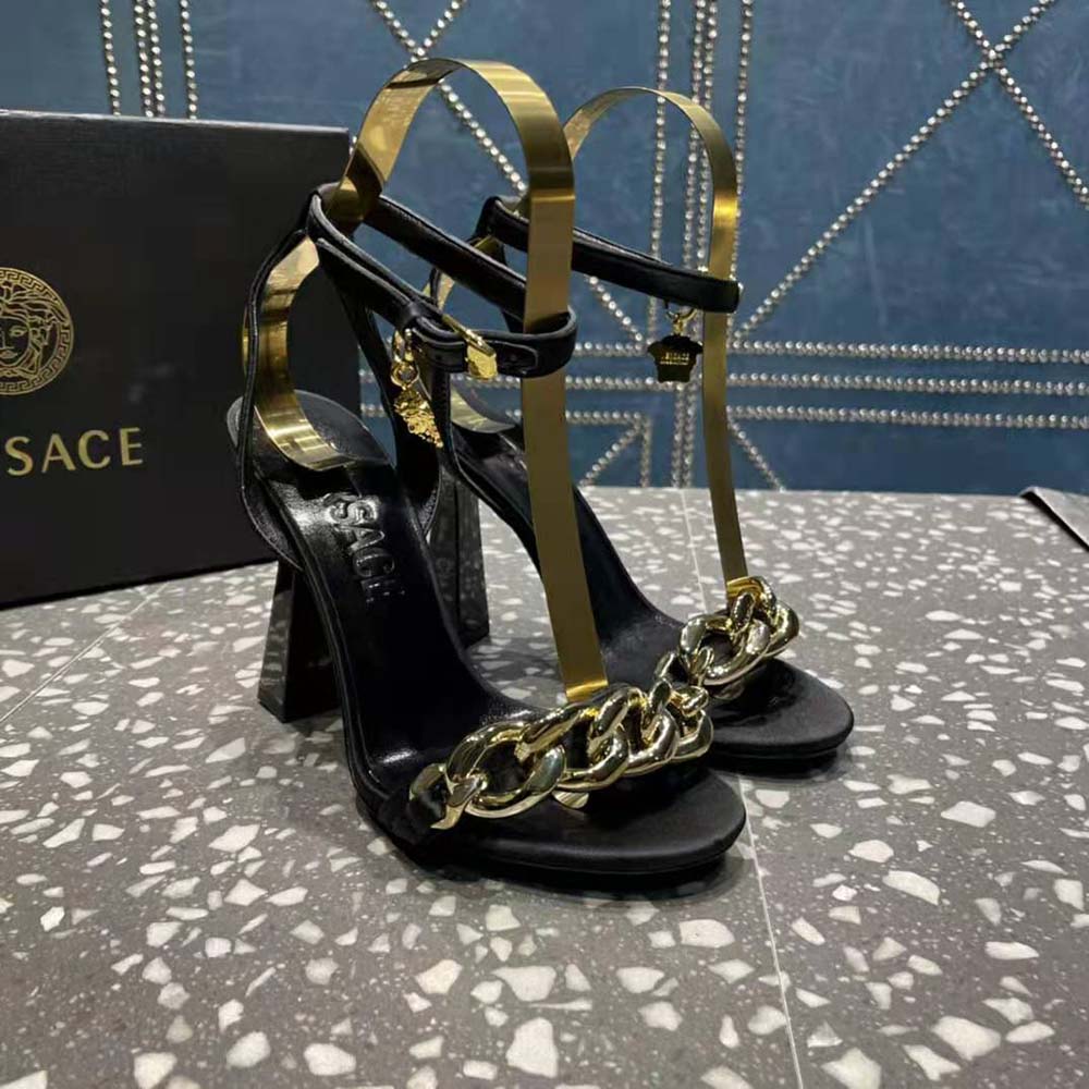 Overhead shot of black leather Versace Women Medusa Chain sandals
