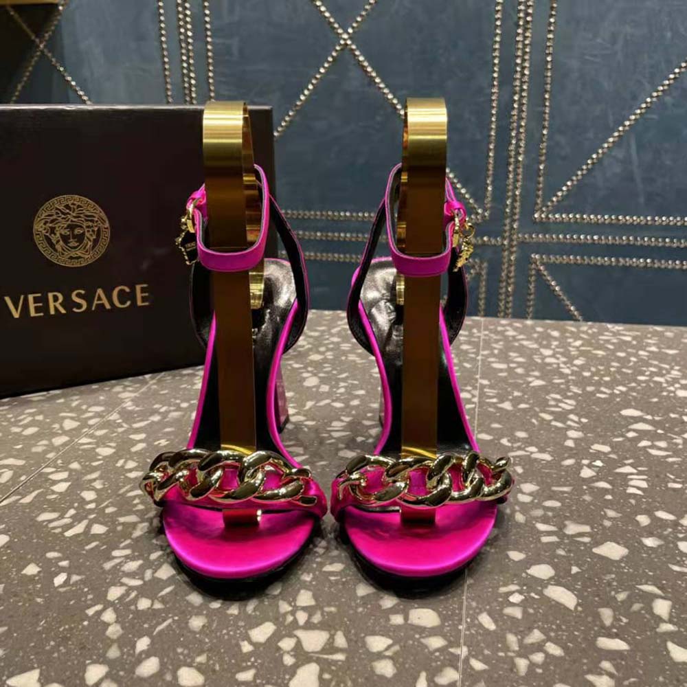 Close-up of rose leather and Medusa chain detail on sandals