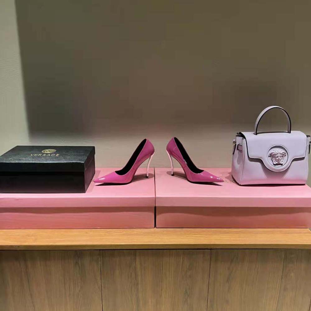 Rear angle highlighting curved high stiletto heel of Versace pink pumps