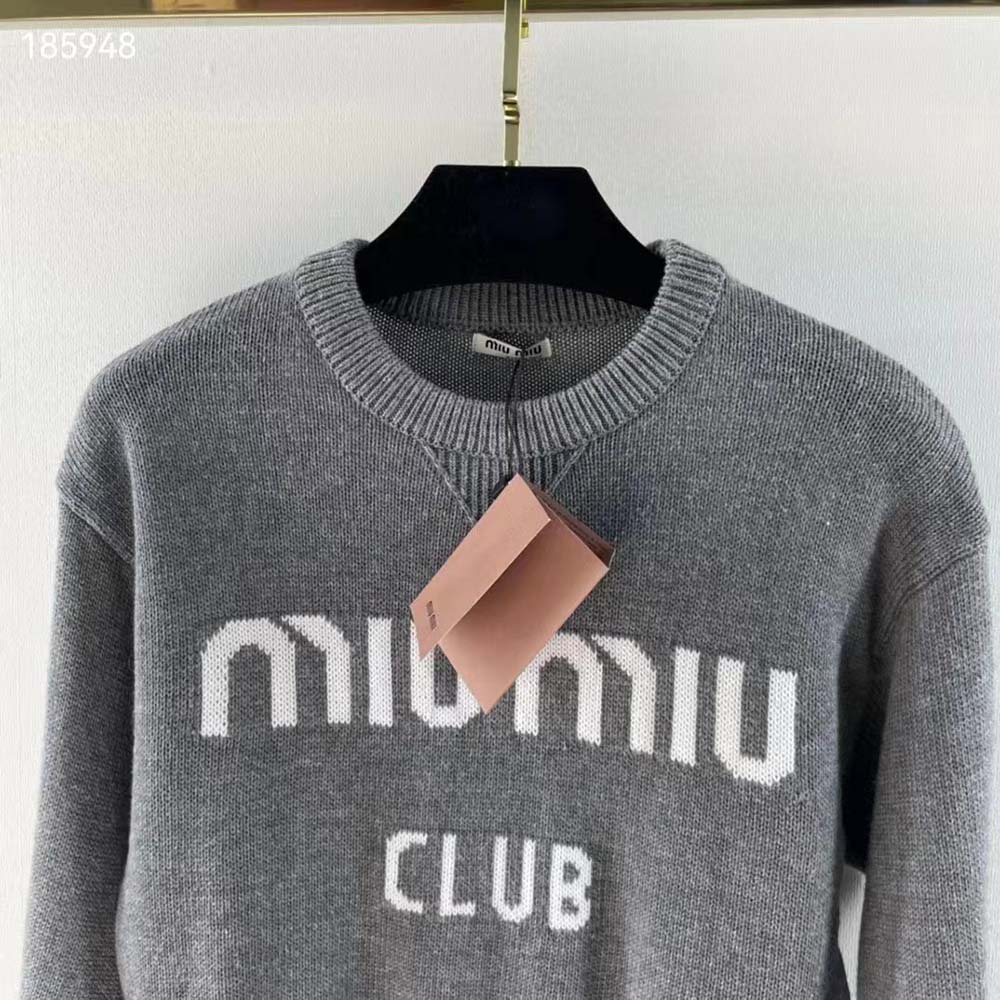 Side angle showing ribbed cuff and neckline of Miu Miu silver sweater