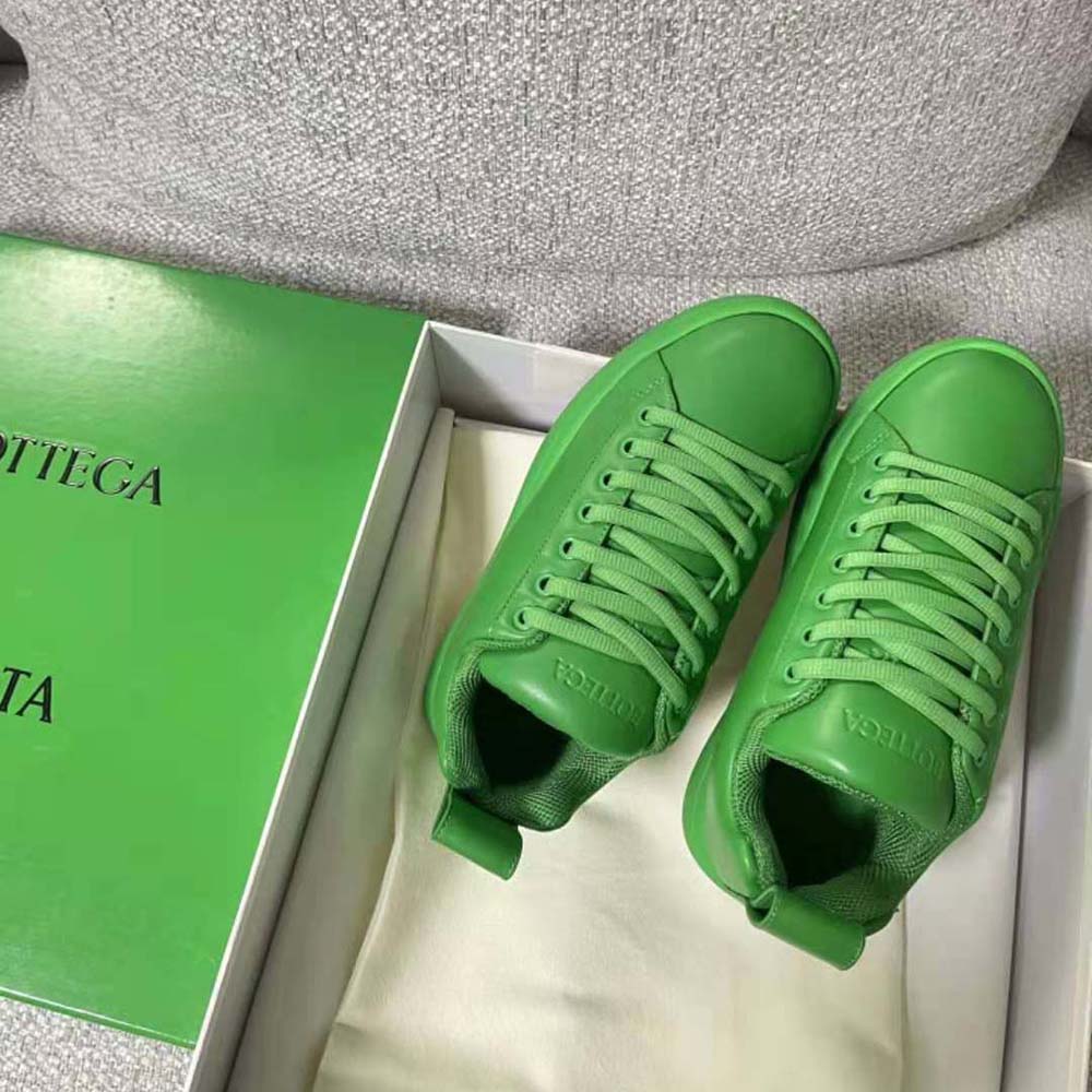 Top view showing silhouette and signature woven detail of green sneaker