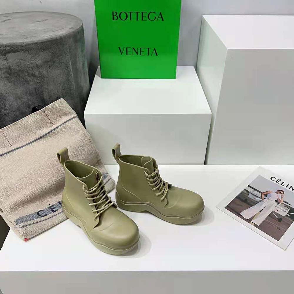 Close-up of green leather and lace detailing on Bottega Veneta Unisex Puddle Lace-Up Ankle Boot-Green