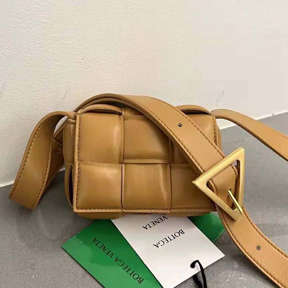 Close-up on gold-tone hardware and padded intreccio leather weave detail