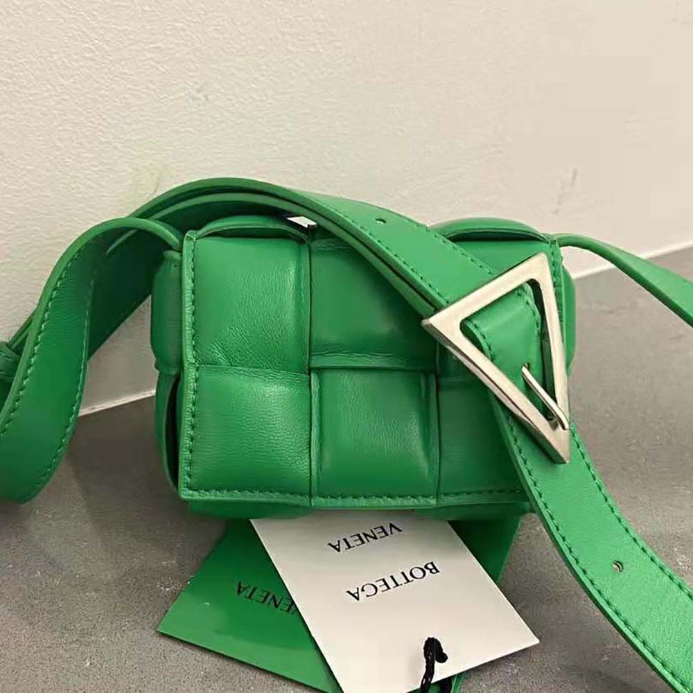 Close-up on green intrecciato leather and gold hardware of Bottega Veneta bag