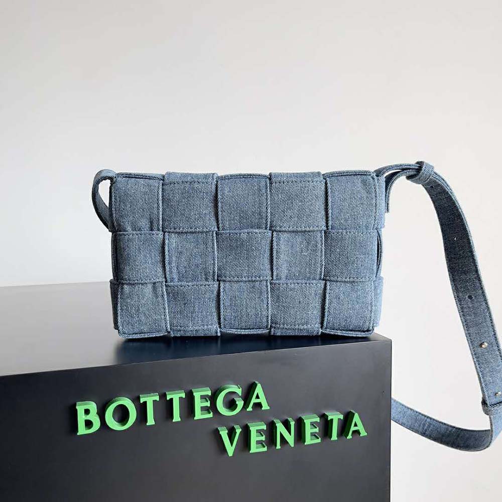 Side angle showing adjustable strap and brushed gold hardware on Bottega Veneta bag