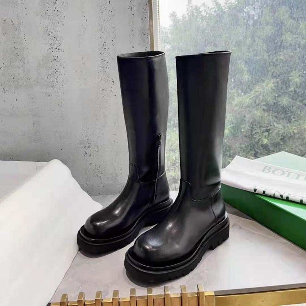 Close-up on black calfskin leather and lug sole of Bottega Veneta boot