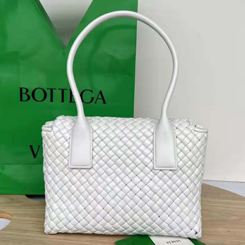 Side angle showing gold hardware and zip closure of Bottega Veneta bag