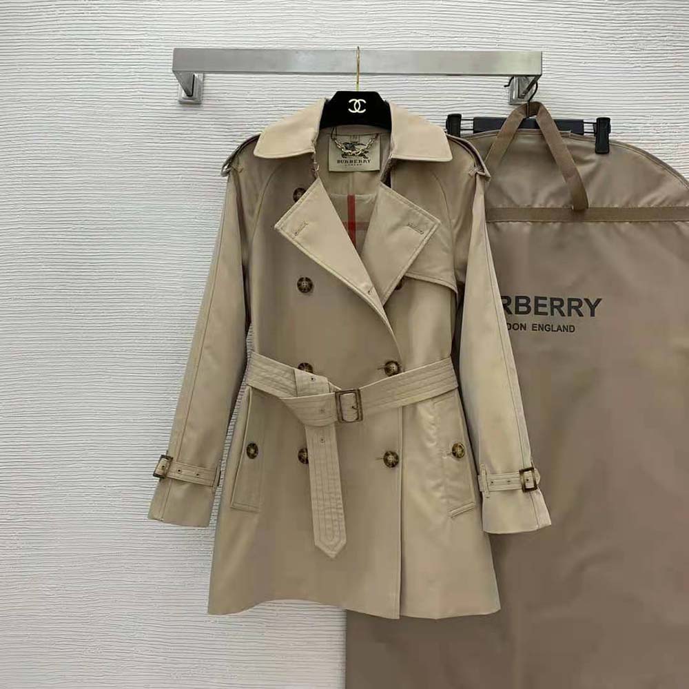 Close-up of Burberry check lining and metal buckle details on coat