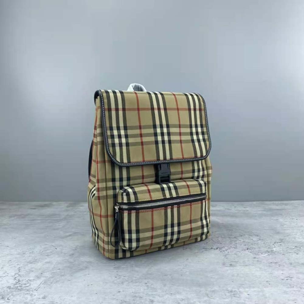 Side angle showing adjustable straps and antique hardware on Burberry backpack