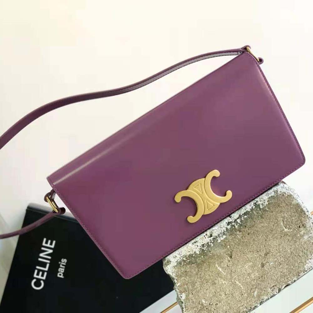 Close-up of gold-tone Triomphe clasp on purple Celine trapeze bag