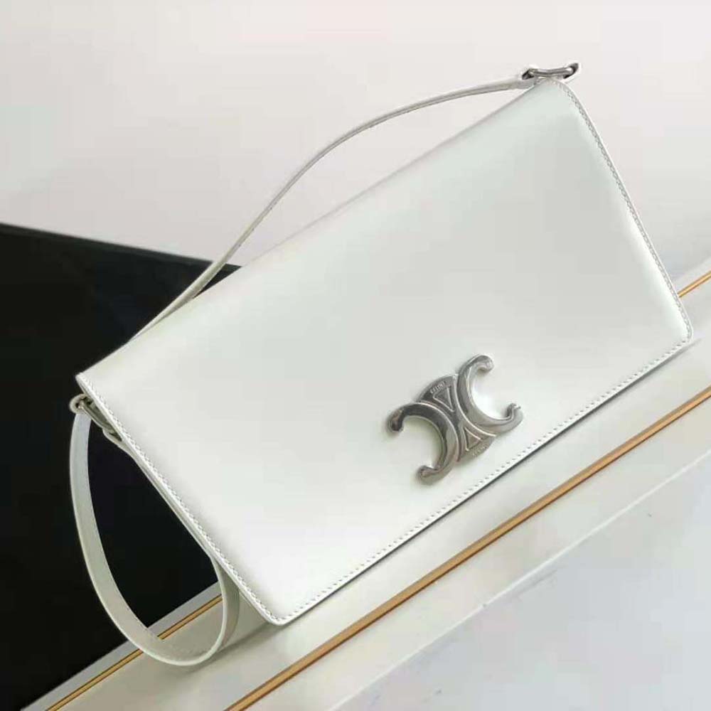 Close-up of gold Triomphe clasp on Celine Women Trapeze Triomphe Bag
