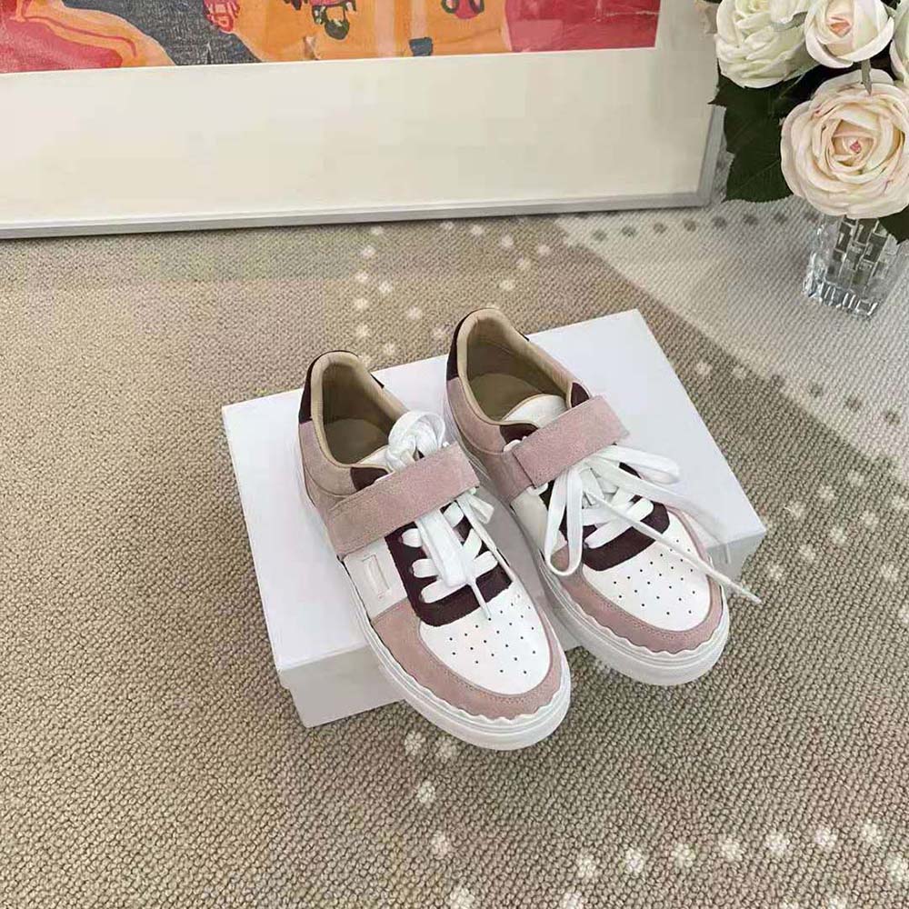 Close-up of pink leather and gold-tone hardware on Chloe Women Lauren Sneaker with Strap-Pink