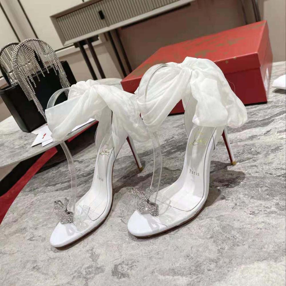 Close-up of glossy white patent leather and red sole on Astrinodo heels