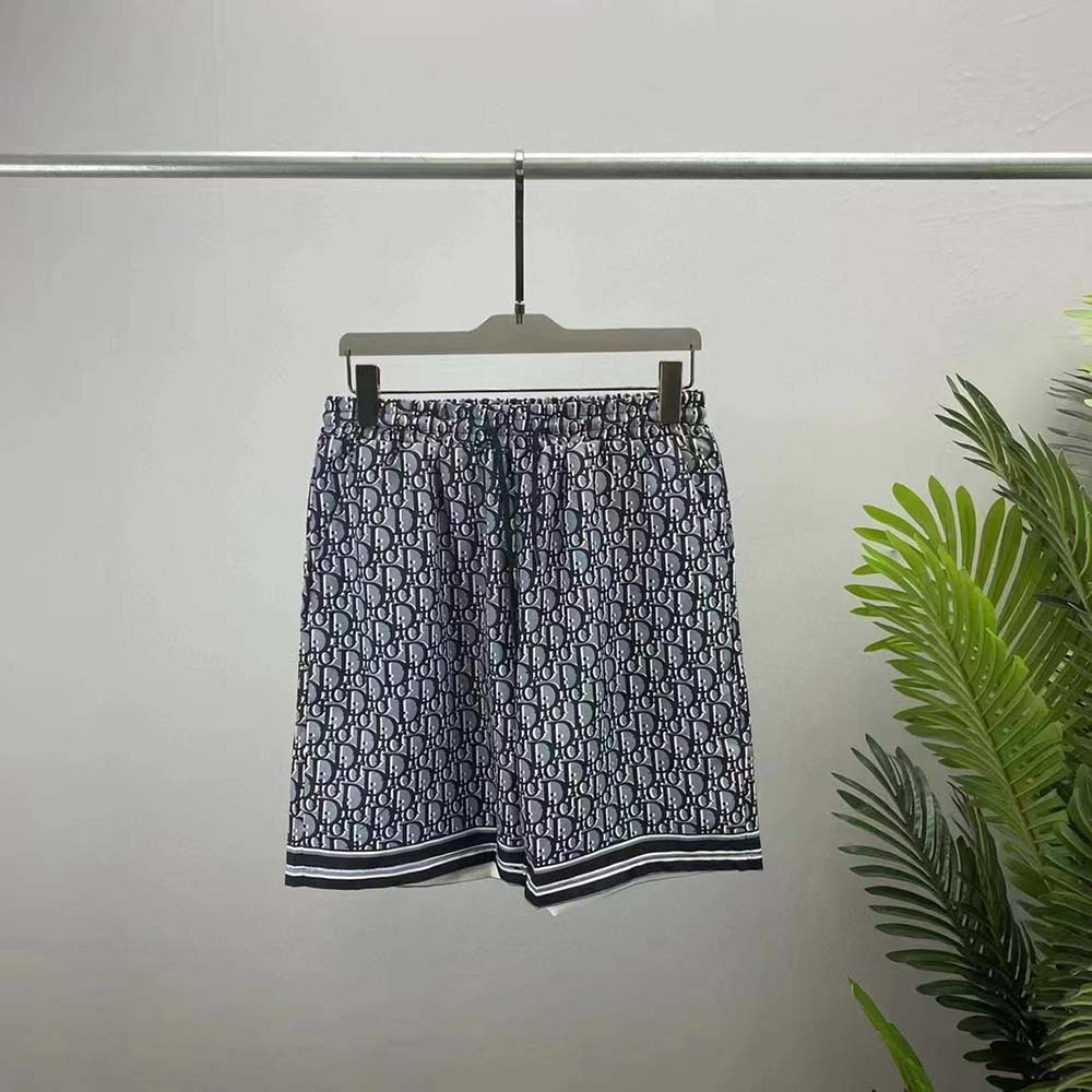 Close-up of Dior Oblique pattern on blue silk twill shorts