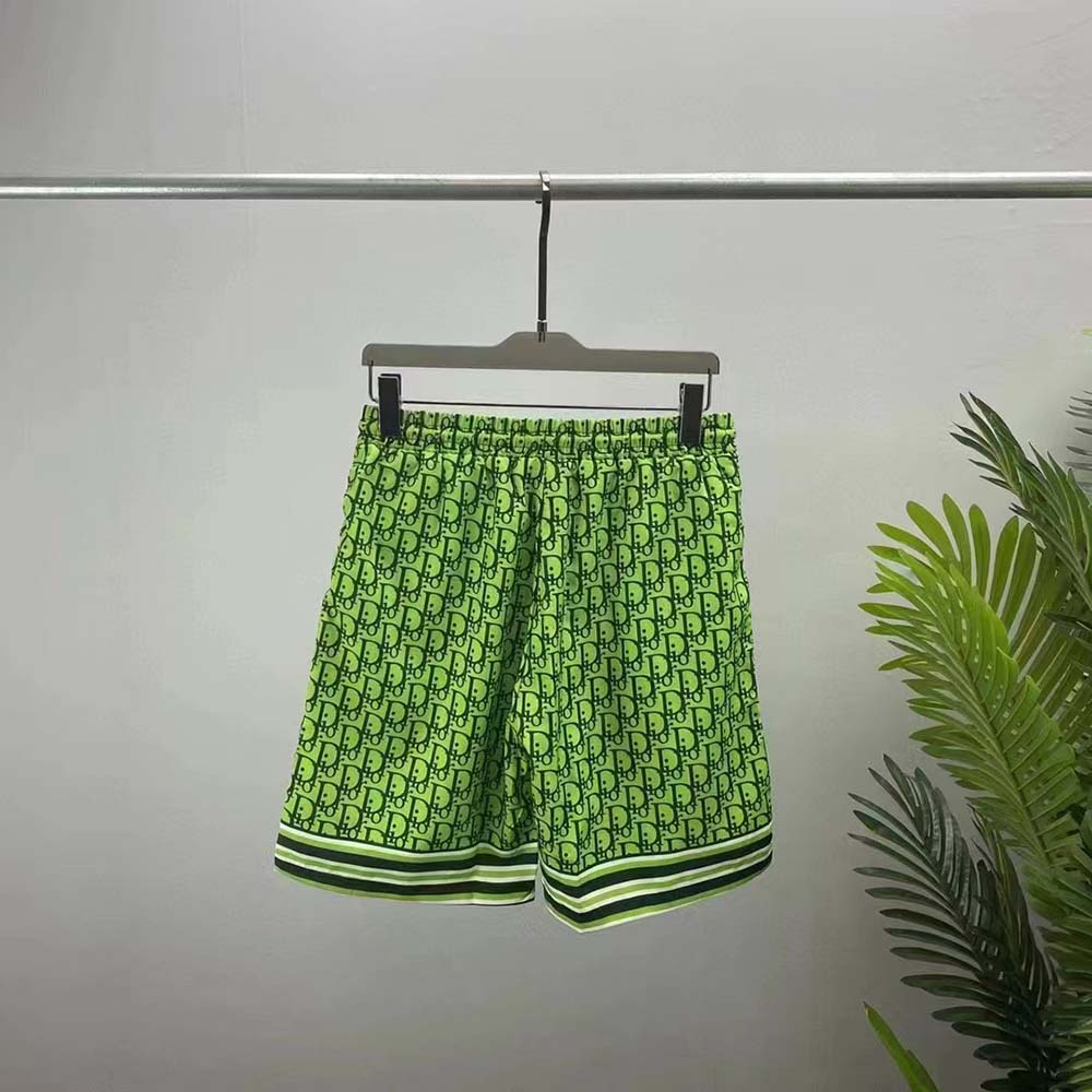 Close-up of Dior Oblique pattern on green silk twill shorts