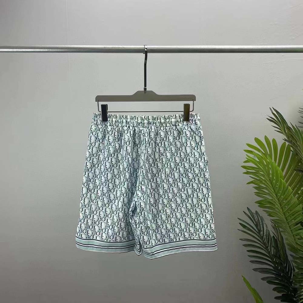 Close-up of signature Dior Oblique silk twill pattern on white shorts