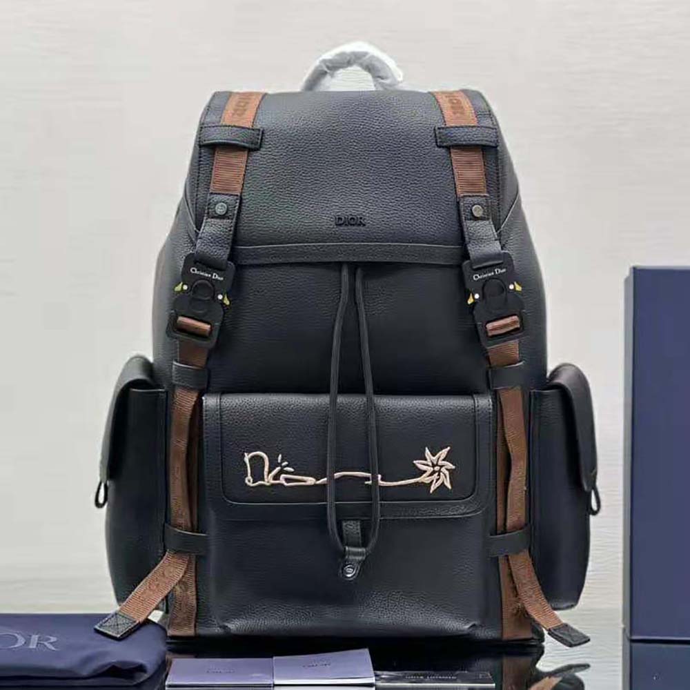 Close-up of embroidered signature detail on Dior Men Hit the Road backpack