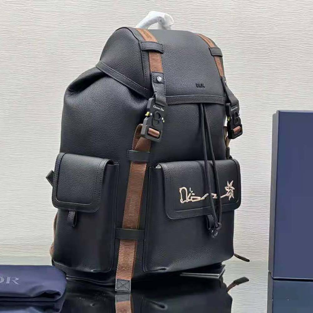 Side angle showing zipper and strap on Dior Men Hit the Road Cactus Jack backpack