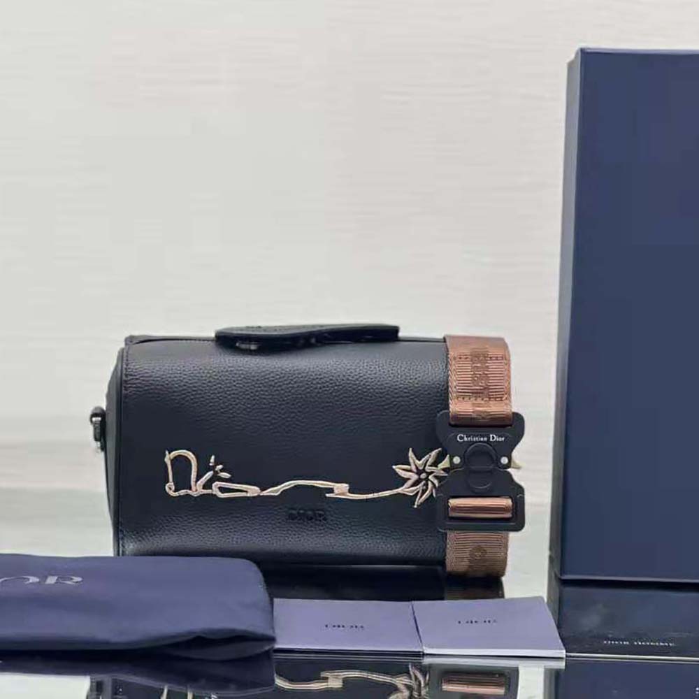 Close-up of embroidered Cactus Jack Dior signature on the black shoulder bag