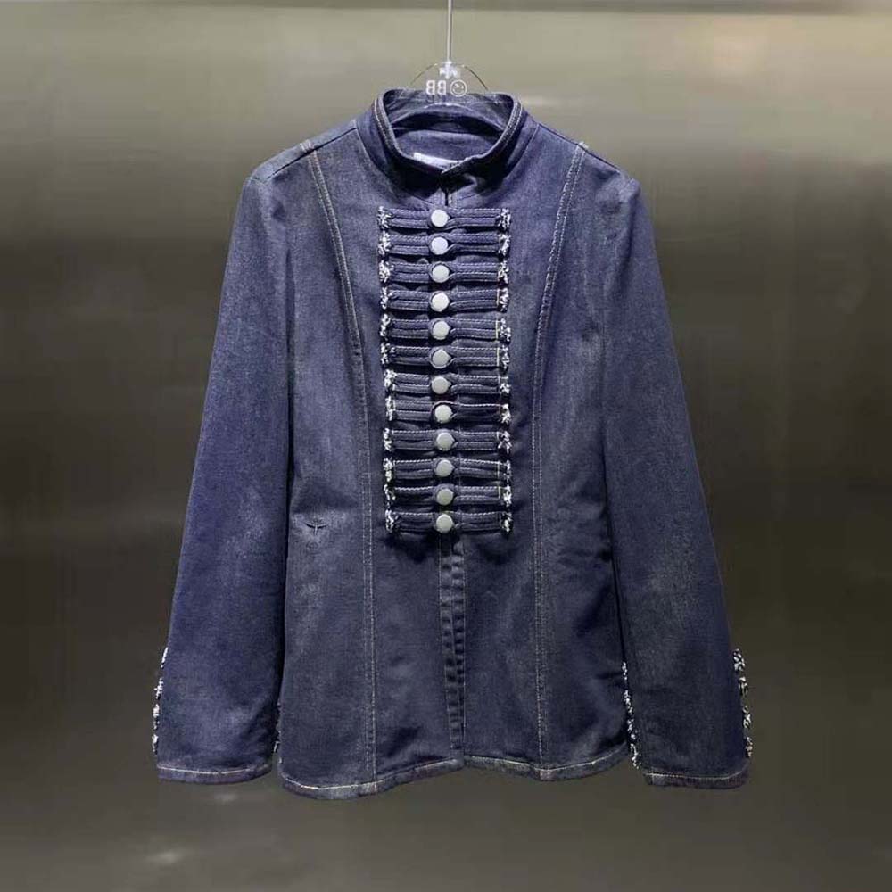 Close-up of silver Dior buttons on blue denim jacket