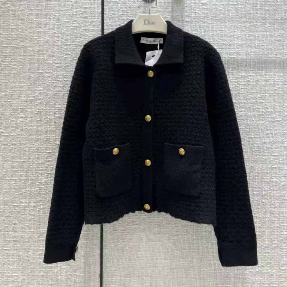 Close-up of signature Dior buttons on black wool knit cropped jacket