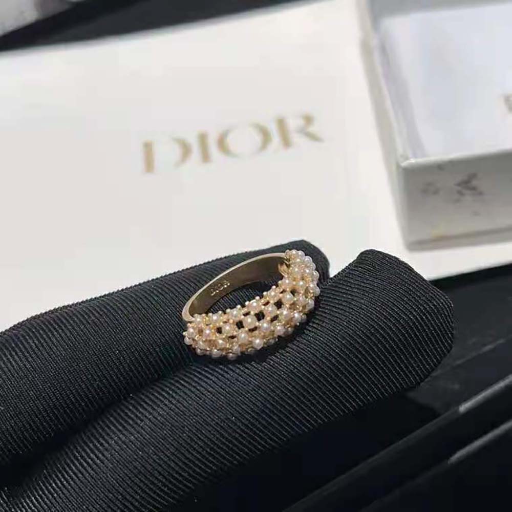 Close-up on white resin pearls and gold-finish detailing of Dior Women D-Renaissance Ring