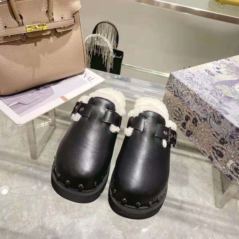Close-up of white shearling lining and silver Dior hardware on clog