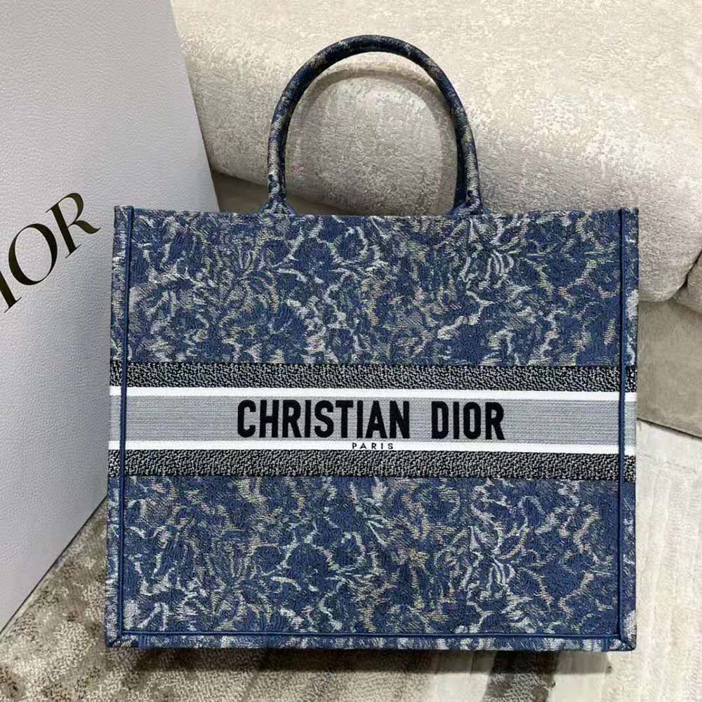 Close-up of blue Dior brocart embroidery and denim texture on large tote