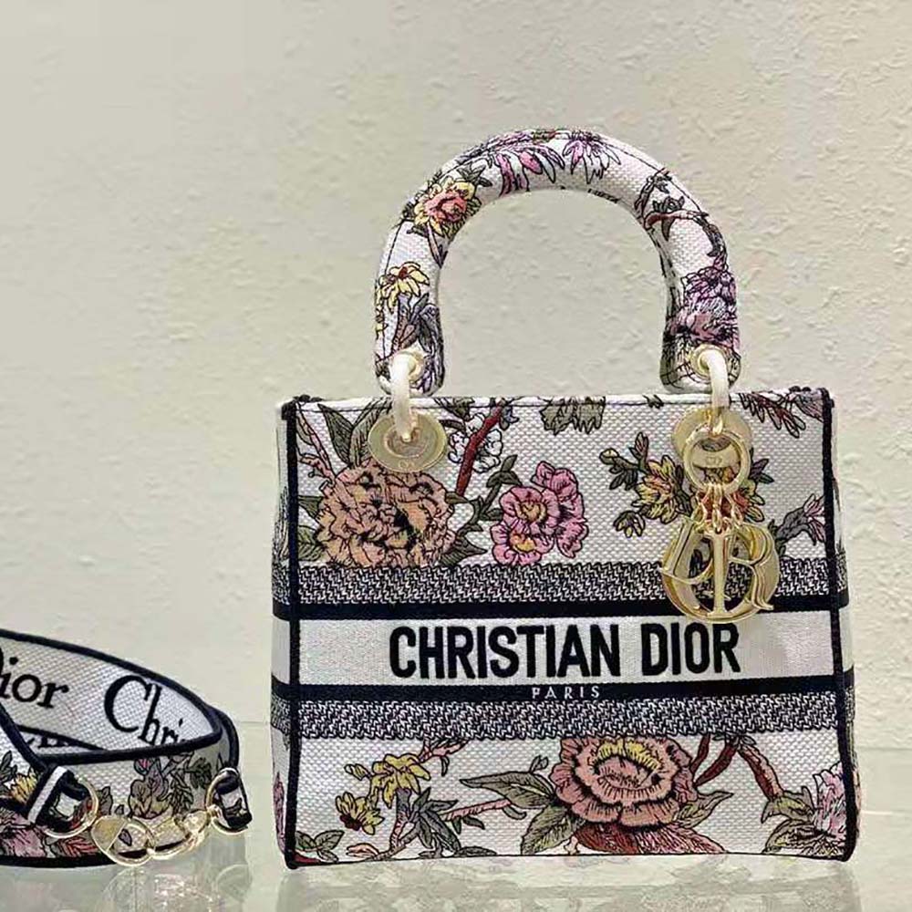 Side angle showing adjustable strap and silver-tone hardware on Dior bag