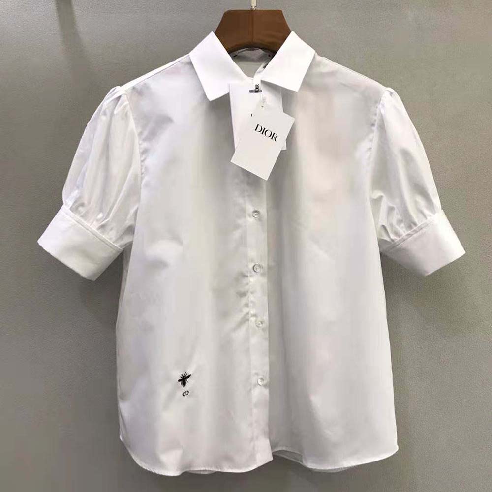 Close-up of puffed short sleeves on Dior white cotton poplin blouse
