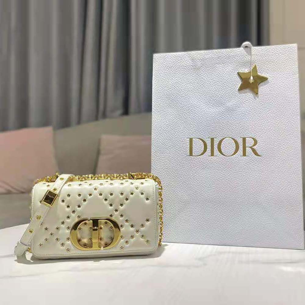 Close-up on gold-tone Cannage hardware and Lucky Star detail on Dior bag